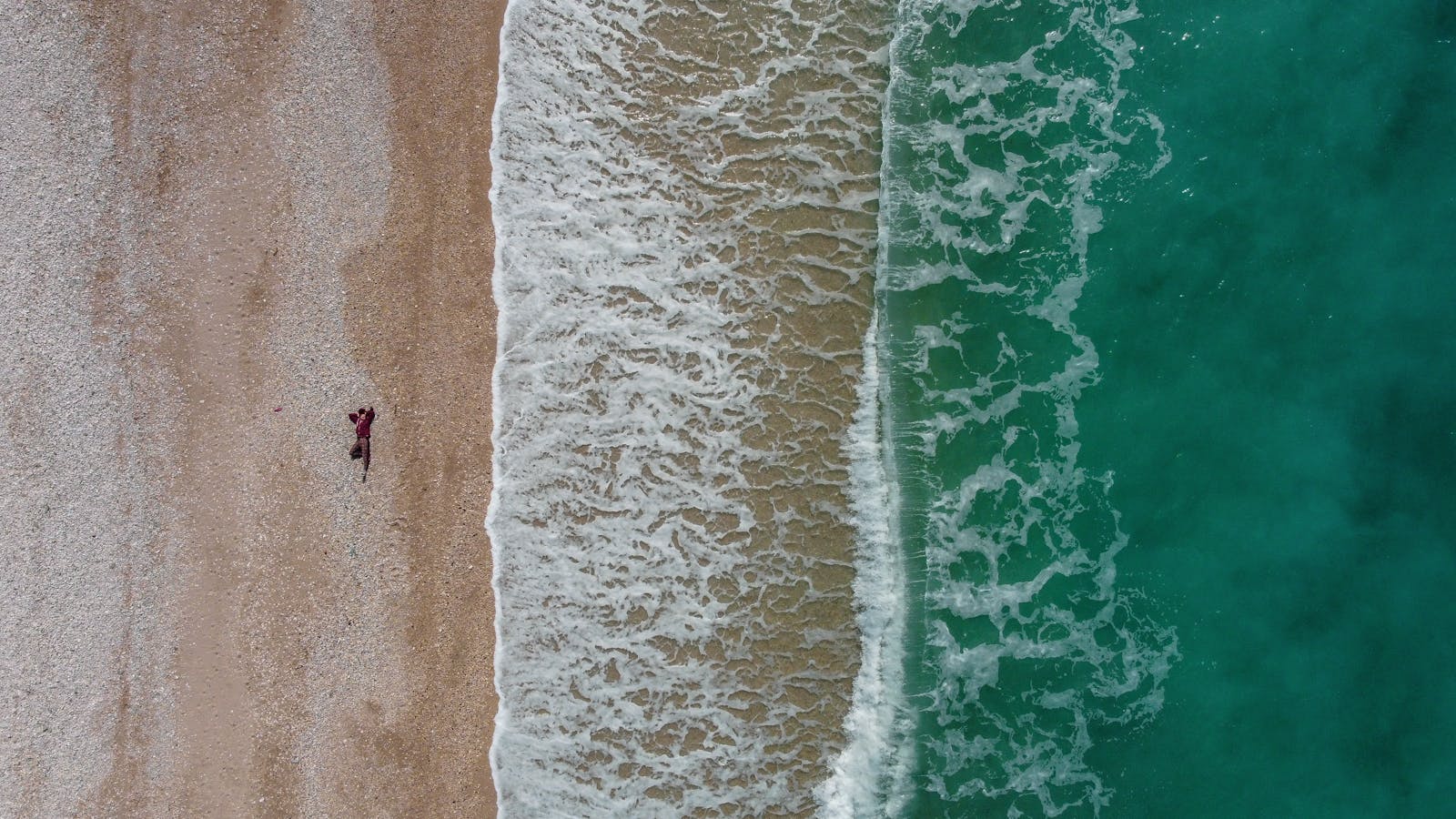 Aerial view of the pebble beach and turquoise sea