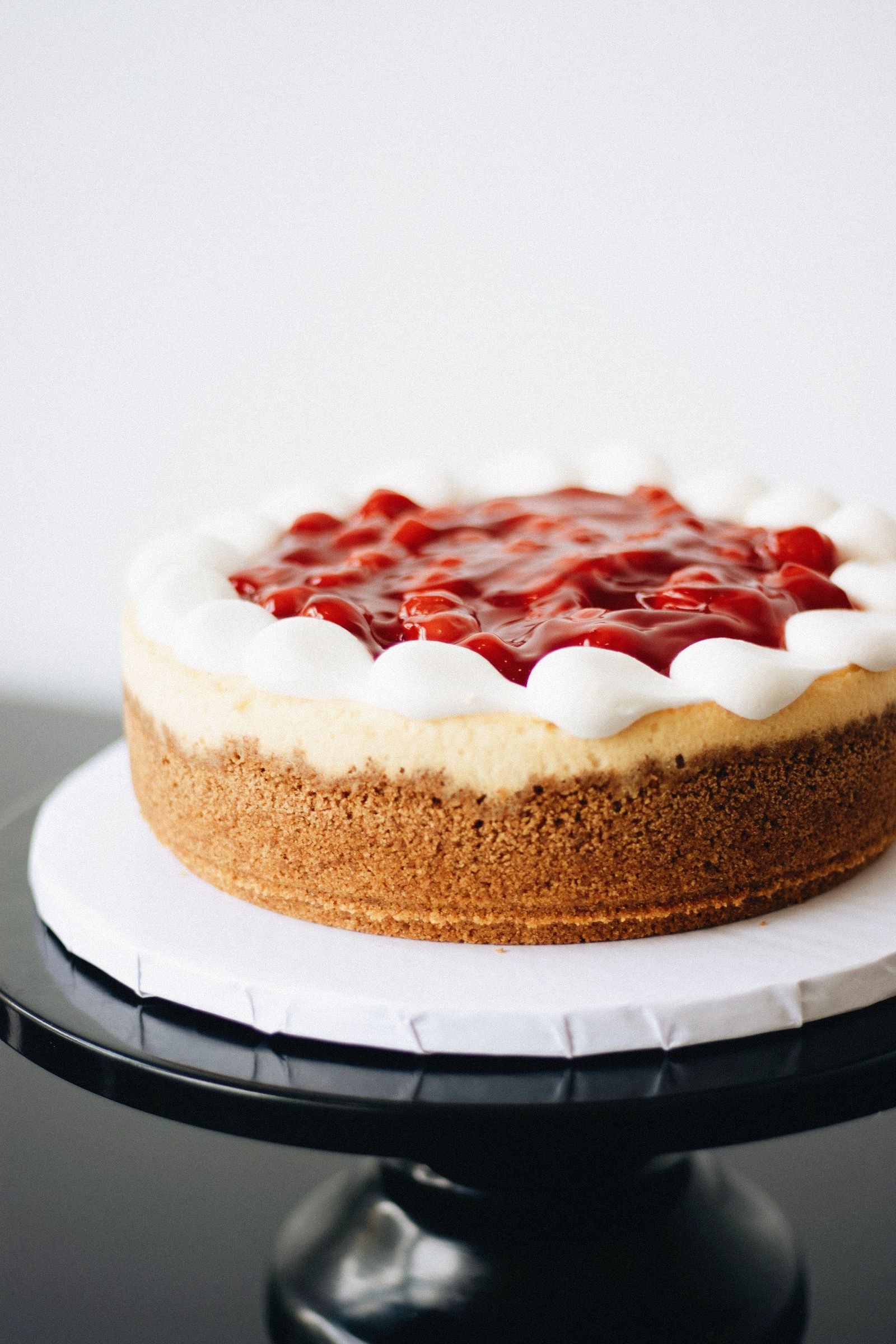 Cherry cheesecake slice with red coulis